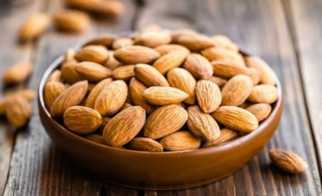 almonds in a bowl on wooden table max f017e almonds in a bowl on wooden table max f017e