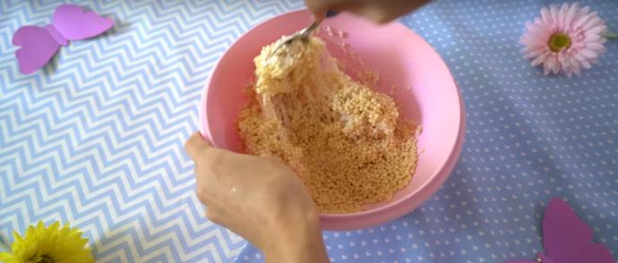 Smícháme rýžové vločky s maršmelounovým krémem. S hmotou by mělo jít pracovat jako s modelínou, dle potřeby tedy přidáme krém nebo vločky.