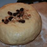 Když je těsto na mazanec vykynuté, zapracují se do něj rozinky a mandle, ale můžou být i oříšky. 