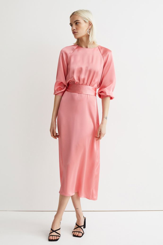 Světle korálové saténové šaty s páskem. H&M, 799 Kč. 
