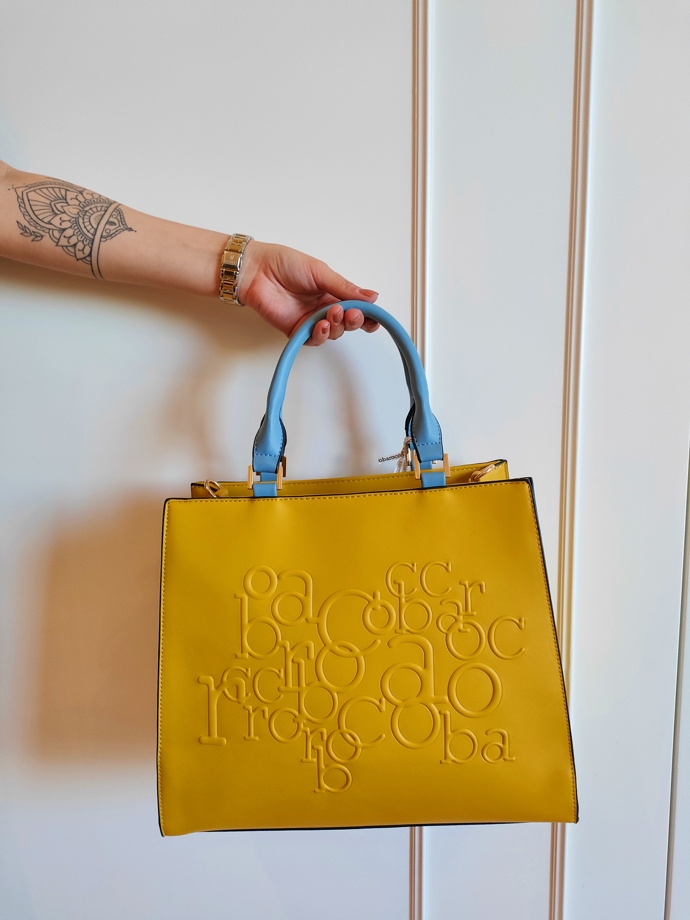 Žlutá kabelka do ruky s modrými držadly. Roccobarocco, Fashion Arena Prague Outlet, 2544 Kč