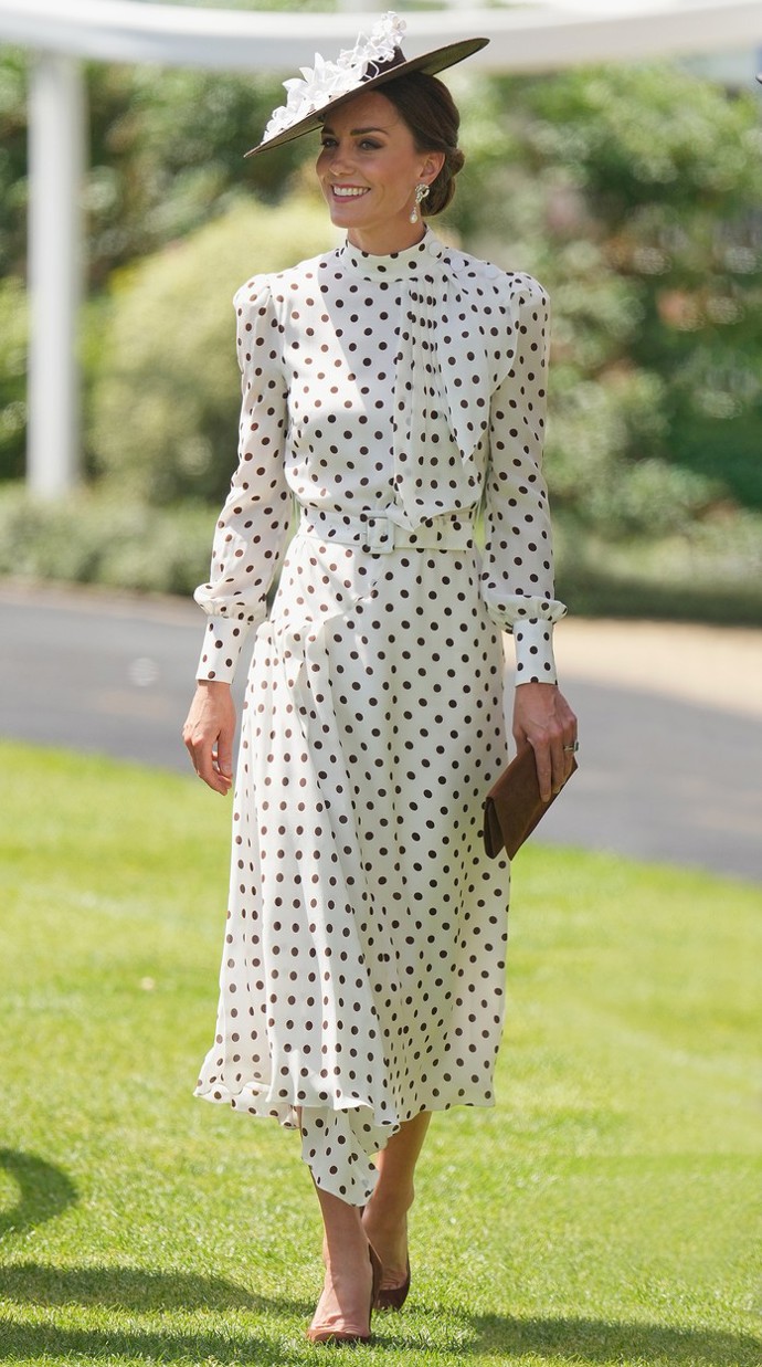 Bílé šaty s hnědými puntíky od Alessandry Rich v kombinaci s kloboukem od Sally-Ann Provan připomínaly outfit princezny Diany z roku 1986 na dostihové události Epsom Derby.