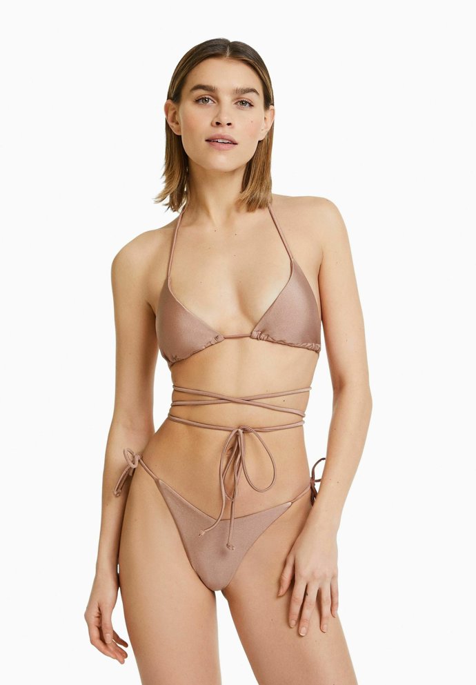 Jednoduché tvary, minimum materiálu, nápadné uvazování. Tři trendy tohoto léta v jednom. (Bershka, 399 Kč a 299 Kč)