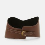 Neokoukaný tvar s typickým zapínáním širokých modelů na úzký proužek s přezkou. (Little Liffner, 7 350 Kč)