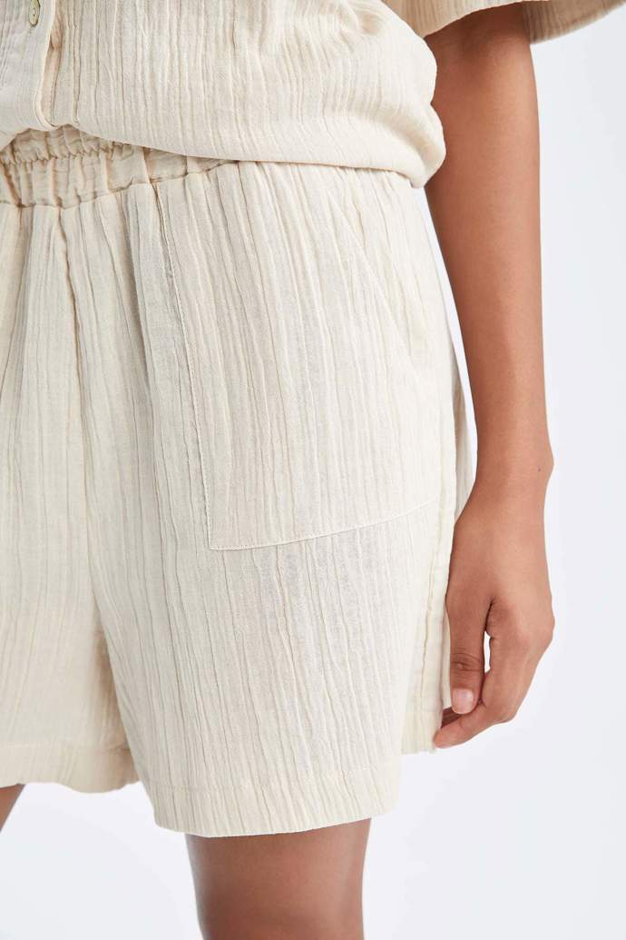 Slonovinově bílé šortky. (De Facto, bezvasport.cz, 999 Kč)