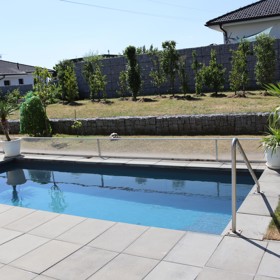 Zahrádce Josefa Maršálka dominuje elegantní bazén, na jehož okrajích stojí exotické dracény.