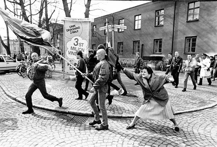 Když v roce 1985 ve švédském městě Växjö pochodovali příznivci neonacistické strany, stařenka, která přežila koncentrační tábor, vstoupila do davu a praštila jednoho ze skinheadů kabelkou do hlavy. Fotografie byla druhý den otištěna v deníku Dagnes Nyheter a okamžitě se stala známou i mimo Švédsko. V tomtéž roce se stala švédskou fotografií roku a magazín Vi ji označil za fotografii století. Stala se jedním ze symbolů boje proti neonacismu. 