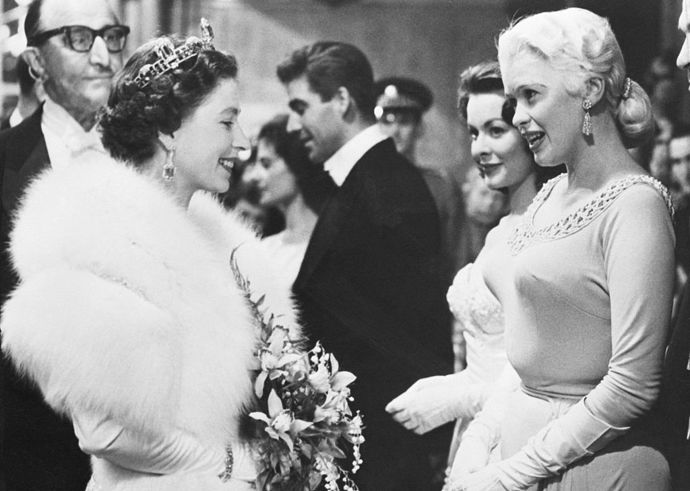 Herečka Jayne Mansfield se s britskou královnou setkala v roce 1957 při příležitosti Royal Variety Performance v Odeon Theatre v Londýně. Na sobě měla světlé šaty s kulatým zdobeným výstřihem.
