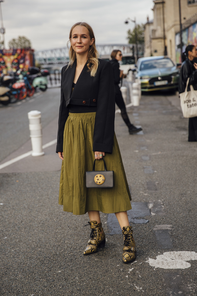 Khaki sukně, zkrácené černé sako, šněrovací špičaté boots s motivem hadí kůže a vtipný detail? Kabelka s plastickou cookie sušenkou.

 
