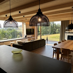 Přírodní minimalistický design a decentní barevná paleta zajišťuje dokonalou eleganci. Velkými okny proudí dovnitř mnoho světla, přes které je možné pozorovat malebnou krajinu, která celou chatu obklopuje. Fasádu domu tvoří ručně štípané modřínový šindel, zatímco uvnitř je obloženo smrkovými biodeskami.
Přírodní minimalistický design a decentní barevná paleta zajišťuje dokonalou eleganci. Velkými okny proudí dovnitř mnoho světla, přes které je možné pozorovat malebnou krajinu, která celou chatu obklopuje. Fasádu domu tvoří ručně štípané modřínový šindel, zatímco uvnitř je obloženo smrkovými biodeskami.