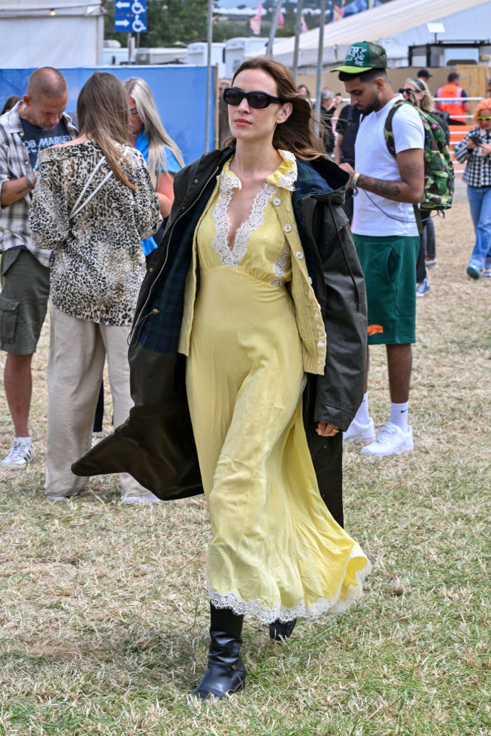 Alexa Chung vyrazila na Glastonbury ve světle žlutých šatech doplněných kozačkami a ikonickým Barbour kabátem proti dešti.

