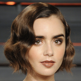 Krátký vlnitý bob sluší Lily Collins.
