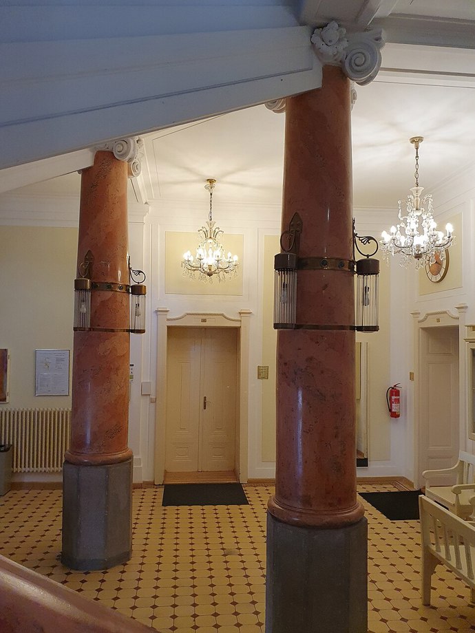 Nová přístavba se k původní radnici chová s pokorou. Reaguje na její tvar i měřítko, ale neuchyluje se k napodobování. Místo ornamentů nabízí čistotu linií, světlo a proporce, které přirozeně zapadají do historického kontextu. 
