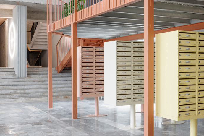 Ve společných prostorách proto zůstalo původní lité terrazzo, mramorové obklady vestibulu nebo travertinový sokl. Opravené byly také původní ocelové konstrukce, schodiště i pavlače. Do interiéru vstupují jasně současné materiály, tahokov, vlnitý plech, nové osvětlení i výrazné barevné akcenty. 
