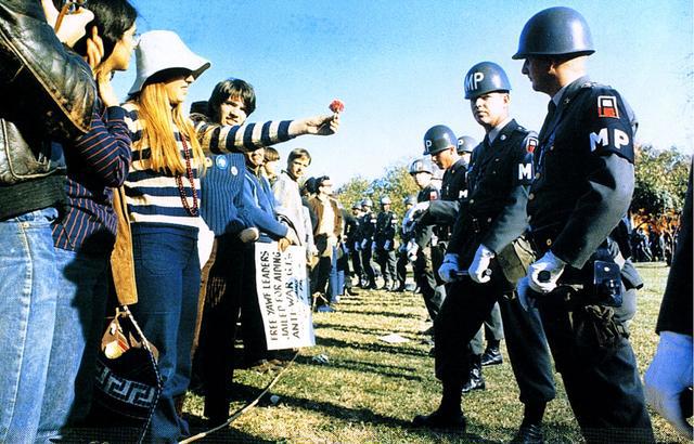 1-Flower_Power_A_demonstrator_offers_a_flower_to_military_police_at_an_National_Mobilization_Committee_to_End_the_War_in_Vietnam_sponsored_protest_in_Virginia_1967 1-Flower_Power_A_demonstrator_offers_a_flower_to_military_police_at_an_National_Mobilization_Committee_to_End_the_War_in_Vietnam_sponsored_protest_in_Virginia_1967