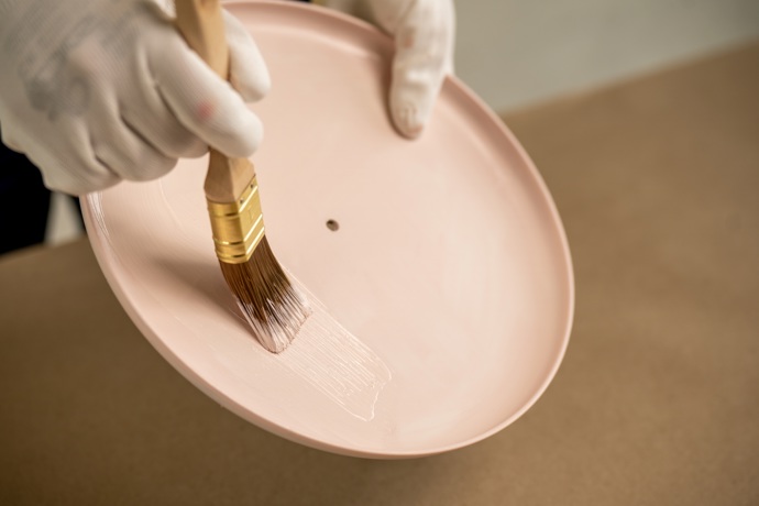 Vezměte barvu a důkladně ji promíchejte. Talíře pečlivě natřete ze všech stran. Vzhledem k tomu, že jde o velikonoční dekoraci, hodí se více svěží jarní odstíny, jako jemně růžová, světle modrá nebo zelená. Pokud chcete něco ještě veselejšího, udělejte každý talíř jinou barvou. 

