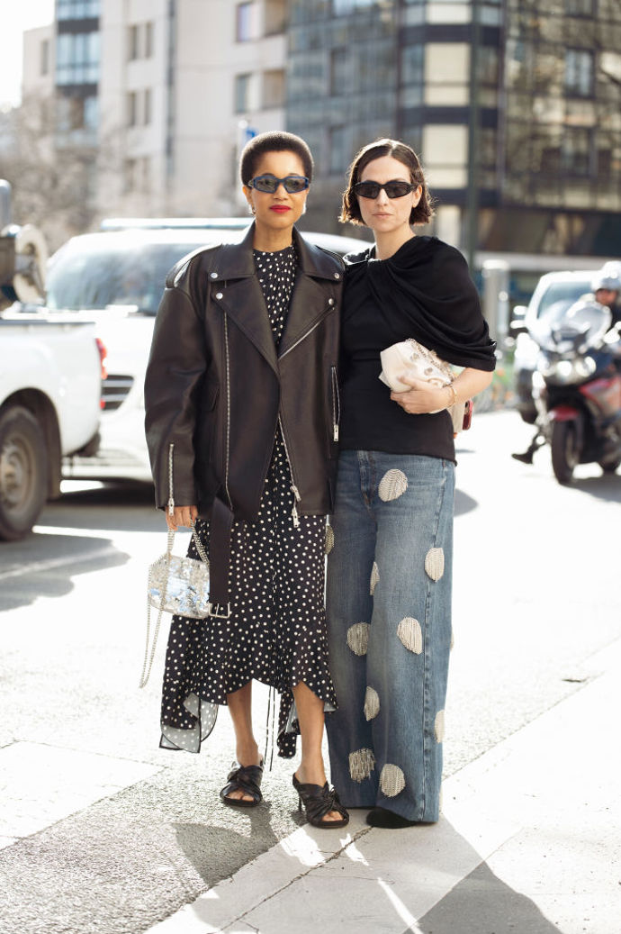 Elegantní černé šaty s bílými puntíky klidně oblečte s tmavě hnědým křivákem v rockovém stylu a jako protiklad přidejte flitrovanou kabelku.
