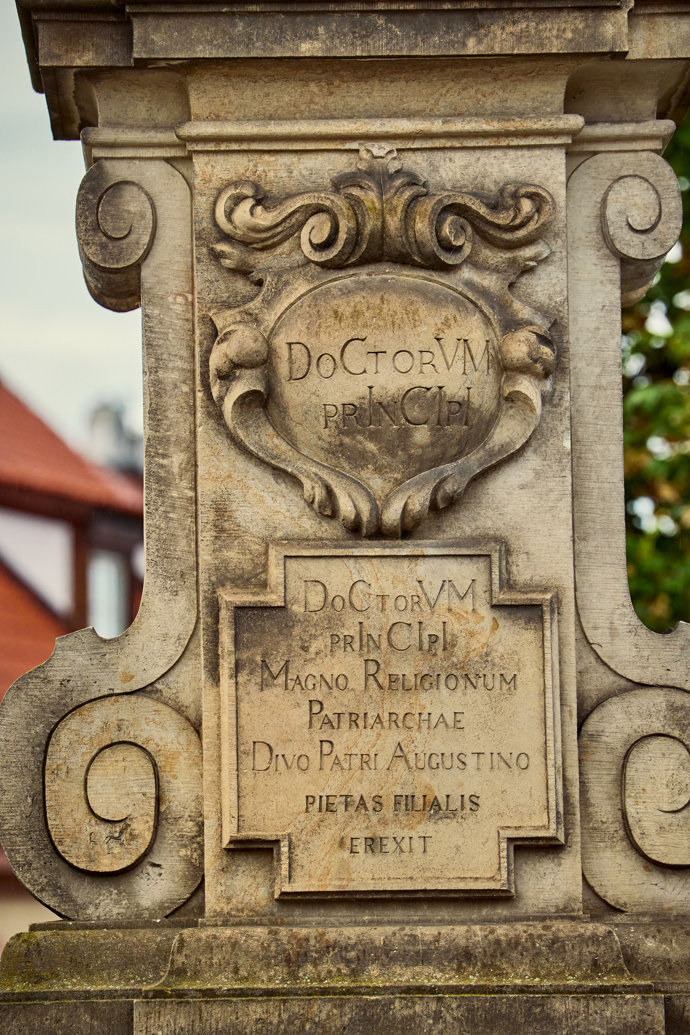 Detail podstavce sochy svatého Augustina na Karlově mostě v Praze.