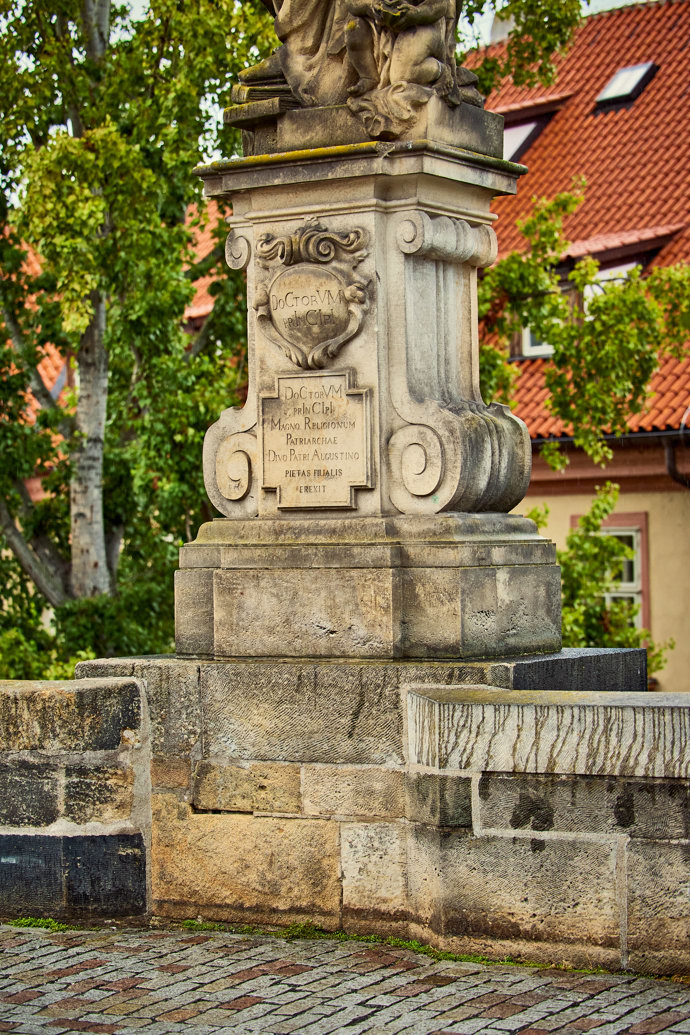 Detail podstavce sochy svatého Augustina na Karlově mostě v Praze.