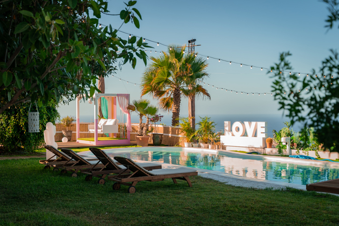 Dominantou vily je rozlehlý bazén obklopený palmami.