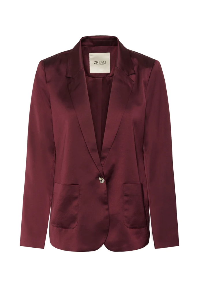 Najdete ale i levnější alternativy, a to jak v odlišných materiálových provedeních, tak jiných nápadných a trendy odstínech, které budou fungovat jako dobrá alternativa. Třeba jako tento saténový blejzr v trendy vínové, který seženete u značky Cream za 2860 Kč.