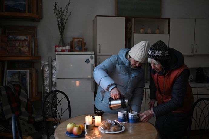 Lidé si v bytech v Kyjeve svítí svíčkami a chodí v bundách.