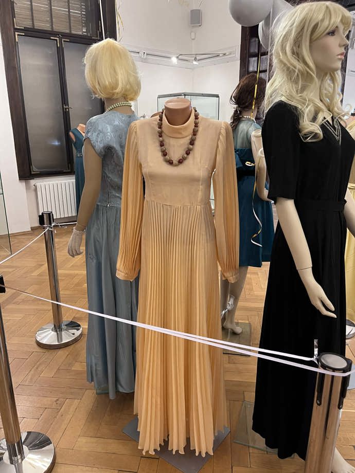 Plesové šaty s plisovanou sukní a výraznou bižuterií. 