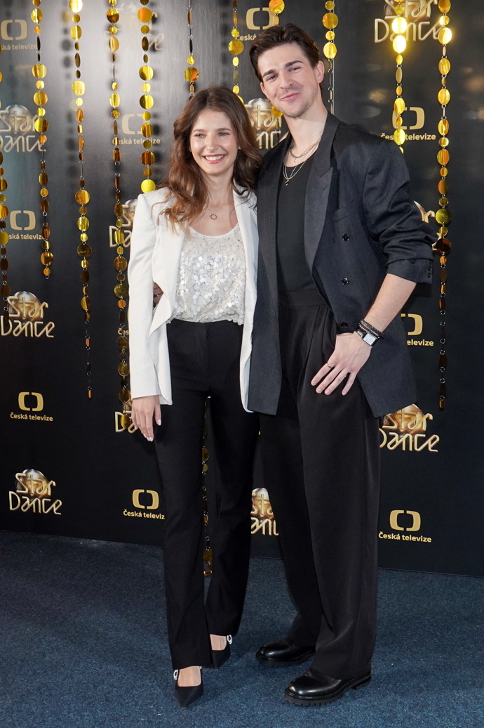 Sara Sandeva a Daniel Makovec. Sara oblékla černé kalhoty s vysokým pasem, pajetkový top a bílé sako. 