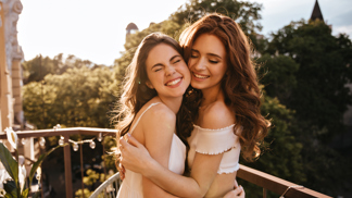 sincere-women-hugging-balcony.jpg (