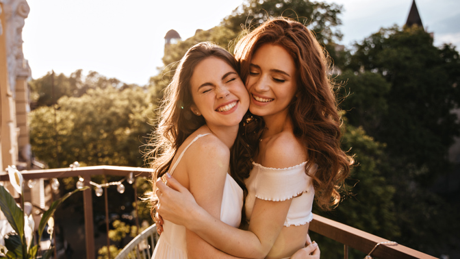 sincere-women-hugging-balcony.jpg (