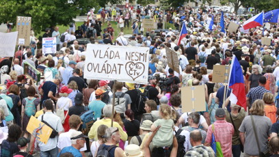 FOTO: Zástup lidí pochoduje ulicí s velkým bílým transparentem na obranu veřejnoprávních médií.