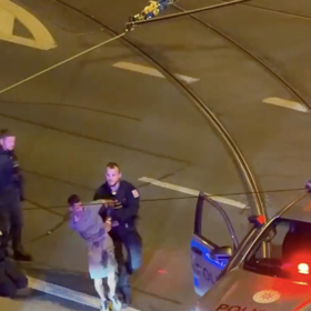Policisté utíkajícího muže spoutali.