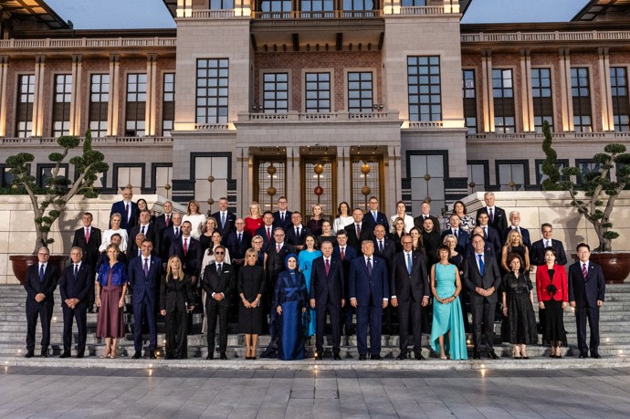 Setkání lídrů na summitu NATO. Zatímco Babiš s Monikou stojí zcela nalevo ve druhé řadě, prezident Pavel stojí zcela vpravo ve druhé řadě. 