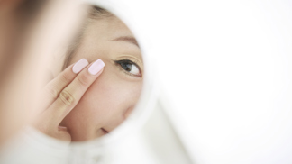 woman looking at self in mirror