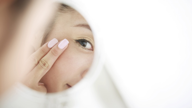 woman looking at self in mirror
