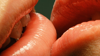 Couple with glossy lips kissing