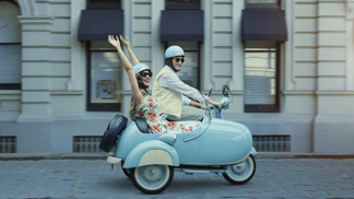 Couple driving scooter