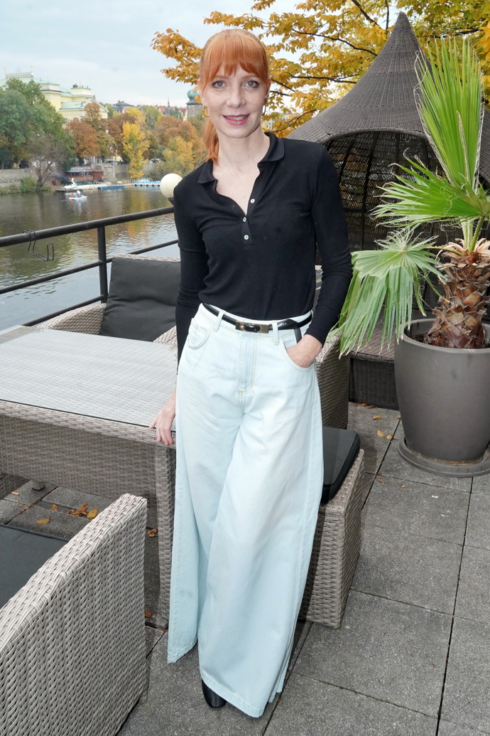 Zpěvačka oblékla černé polo tričko s dlouhým rukávem a široké bílé kalhoty s vysokým pasem. 