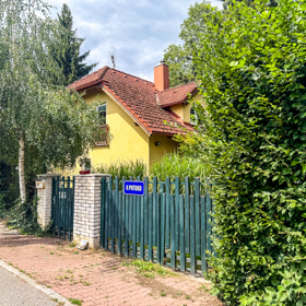 Domek je díky bujné zeleni ukrytý před zraky kolemjdoucích.