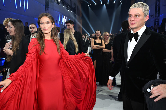 Modelka předvedla nápadné rukávy svých rudých šatů.